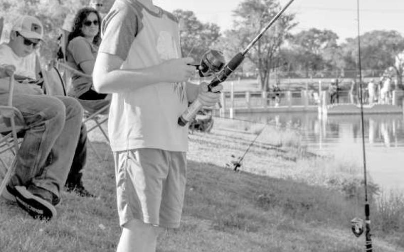 FISHING FUN - Pictured is Nash Jones who was focused on his line during Casting With Cops last Saturday at Lobo Lake. (Staff photo by Ada Niederhauser)