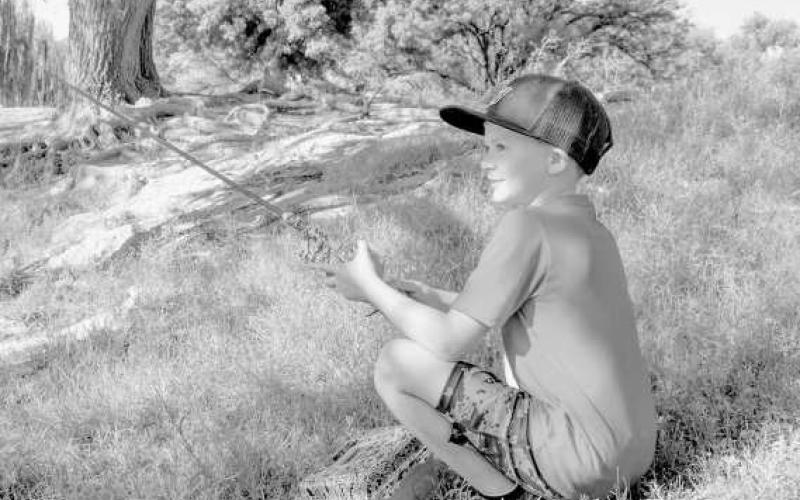 QUITE THE PROFESSIONAL - Pictured is Rantley Friesen who was spotted with his tackle box and line at Lobo Lake at Casting With Cops last Saturday. (Staff photo by Ada Niederhauser)