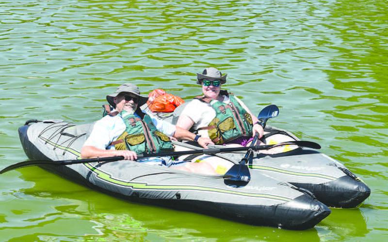 KAYAK TIME: Carl and Amy Woods are enjoying the summer day as they kayak on the Lobo Lake Wednesday. Amy said it was a chill out kind of day and they do it as often as they can. She would also like for other people with kayaks to join them. (Staff Photo by Emily Campos)