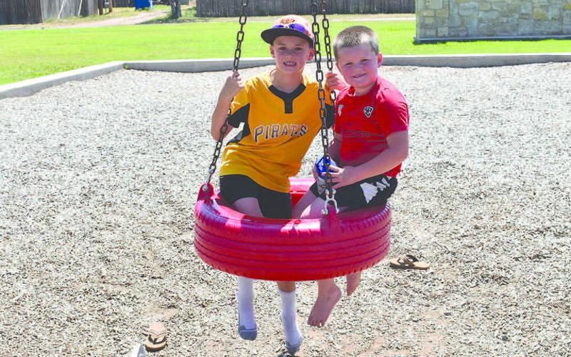 SUMMER FUN: Brothers Jeremy and brother Eli Witt were having fun at the Bartlett Park, Wednesday and beat the heat by going earlier in the day. The brothers where enjoying playing on all of the equipment at the park. ( Staff Photo by Emily Campos)