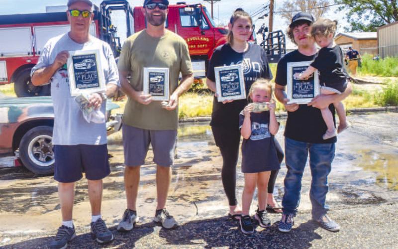 BURN OUT CONTEST- Pictured from left to right are: 1st place winner Frank Swain, 3rd place winner Brent West and 2nd place winner along with King of the Hill Brody Henry and family. All three individuals led the burnout competition. (Photo courtesy of Emily Campos)