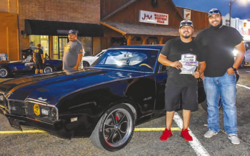 1968 OLDSMOBILE 442- Pictured is J.D. Ramirez who is the proud owner of a 1968 Oldsmobile 442. Ramirez was presented with an award from Evariseo Rodriguez for one of the best cruisers on the cruise on Friday night. (Photo courtesy of Emily Campos)