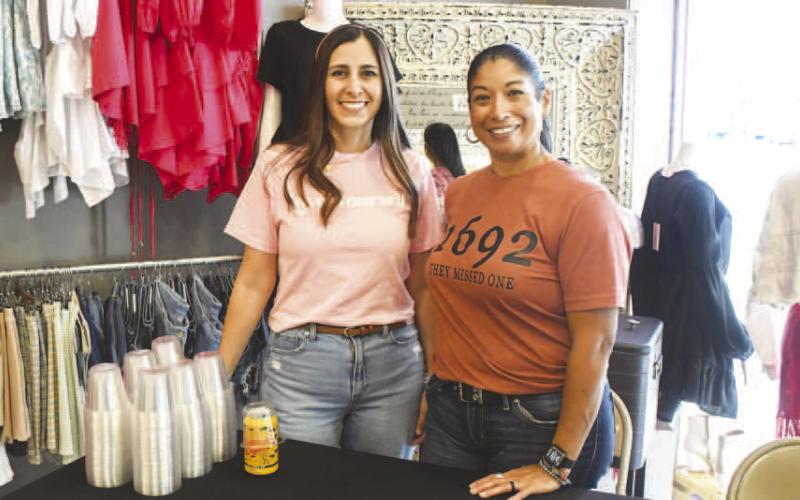 Amanda and Roxann served Sip and Swirl attendees beer inside K’s Glamour Corner in downtown Levelland on Friday night. (Staff photo by Evin Thomas)