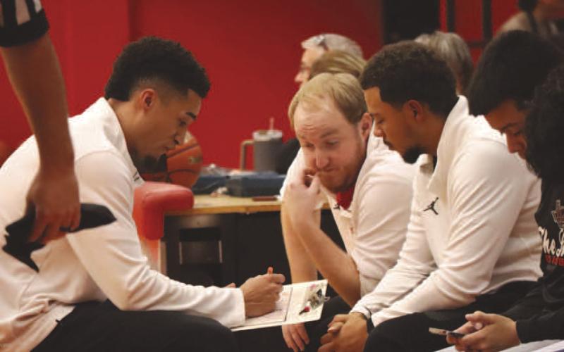Levelland Lobo Head Basketball Coach Jordan Windholz and his coaching staff went over a few things they saw during the halftime break of their game against Jayton. (Staff photo by Aalijah Soliz)