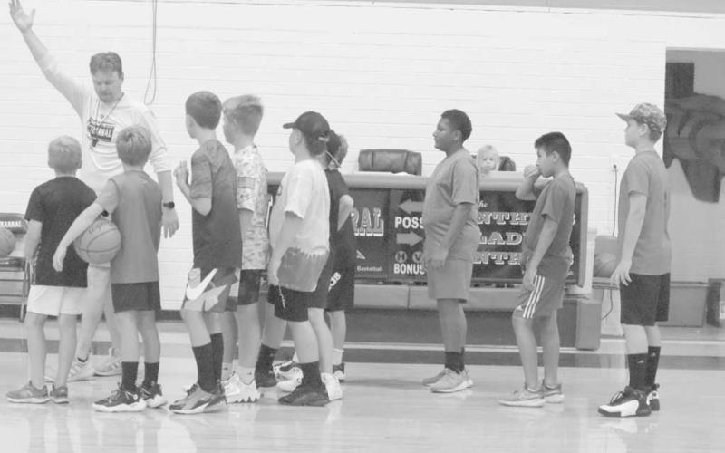 LAYUP LINES - Whitharral Head Coach Matt White taught kids the right way to do a lay-up for basketball. (Staff Photo by Aalijah Soliz)