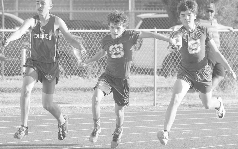 BATON HAND-OFF- The Sundown Roughette seventh and eighth grade track teams won district championships in track. The Roughneck seventh grade team placed fourth and the eighth team placed third. Roughneck sprint relay runner Kale Strickland hands the baton to teammate JC Jenkins. (Photo Courtesy of Sundown ISD)