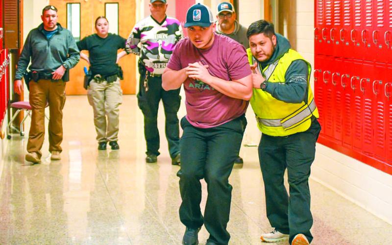 NECESSARY EVIL - Levelland Police Officers Blake Parker and Emilio Miranda demonstrated the proper technique for maneuvering through hallways and classrooms during an active shooter threat Tuesday afternoon at the Levelland Intermediate School. LPD Captain Mateo Lopez explained that the training has become a necessary evil as active threats in schools remain a possibility. (Staff photo by Dom Puente)