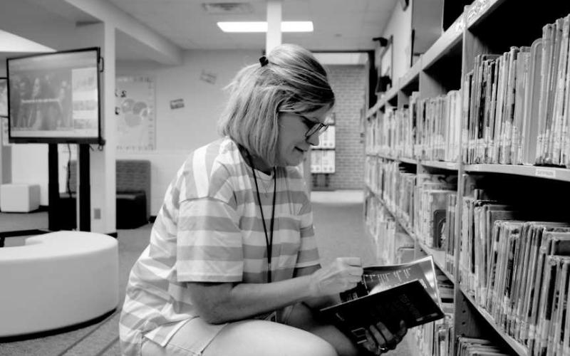 BOOK MATCHMAKER - Capitol Elementary School librarian, Pam Alexander was seen setting out books and making the library a nice and cozy place for children to relax and read. (Staff photo by Hannah Woodrum)