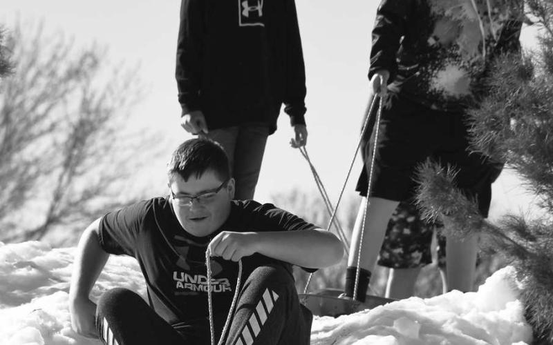 FUN WITH FRIENDS - Friends, siblings and family got enjoy the first day of the Lobo Lake Sled Hill. Family members and members of the community were on standby enjoying the free entertainment of children riding sleds down the different trails provided. (Staff Photo)