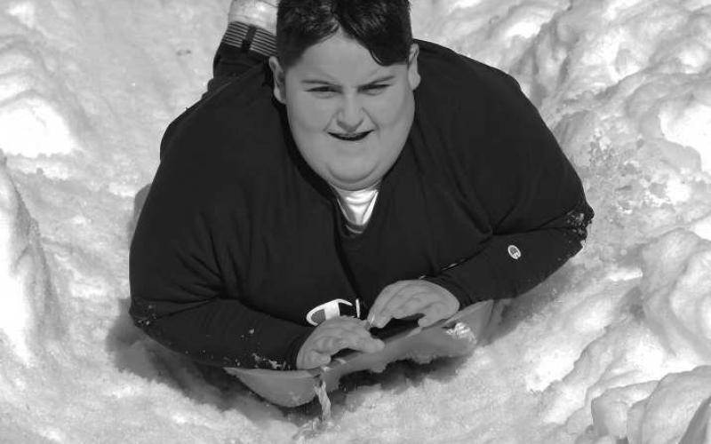 ALL SMILES - Kids of all ages have been encouraged to play at the Lobo Lake Sled Hill during the final week of 2022. City employees with the parks department continue to be on hand to ensure child safety. (Staff Photo)
