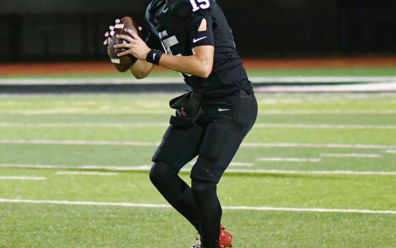- Levelland starting quarterback scans the field to try and find an open man during a football game against Estacado this past Friday at Lobo Stadium. (Staff photo by Jentezen Smith)