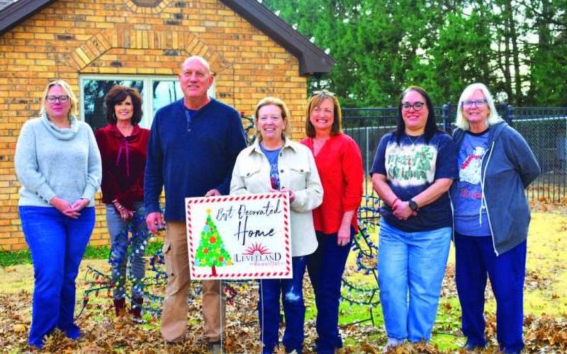 Home owners Kurt and Kelly Martin were selected as one of this years winners for the Keep Levelland Beautiful annual Best Decorated Home of the Month for the 2023 holiday season.Pictured from left to right are: Kelly Hancock, Janie Mireles, Cristal Isaacks, Kurt Martin and wife Kelly Martin, Donna Wheeler and Tammy Franklin. Awards were presented the week before Christmas.(Staff photo by Emily Campos)