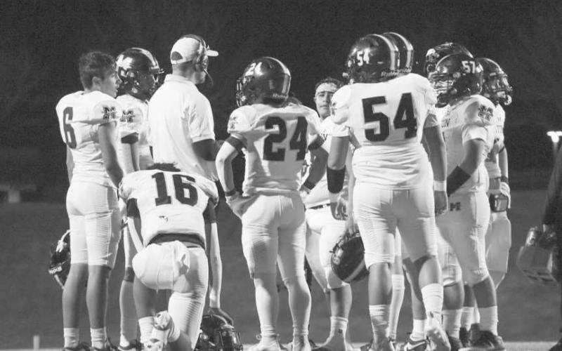 HUDDLE - The Morton Indians huddled up around Head Football Coach and Athletic Director Kieth Mauldin during the team’s game against Gruver in Amarillo. (Staff photo by Aalijah Soliz)