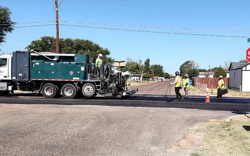ROAD WORK ON SHERMAN - The city road project slowed traffic as microsurfacing was underway on Sherman on Wednesday.