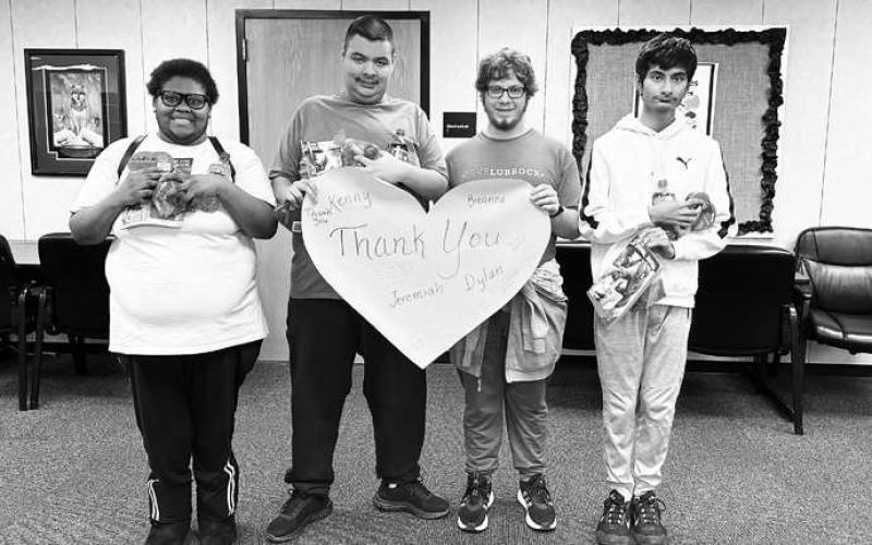 VALENTINE SURPRISE - LHS LibraryAide Lorena Sanchez surprised LOC students with Valentine’s Day treats. Sanchez says the students are always eager to help keep the LHS library clean. Pictured from left to right are: Breanna Robinson, Jeremiah Moreno, Dylan Pope and Kenneth Rodriguez. (Photo courtesy of Cristal Isaacks)