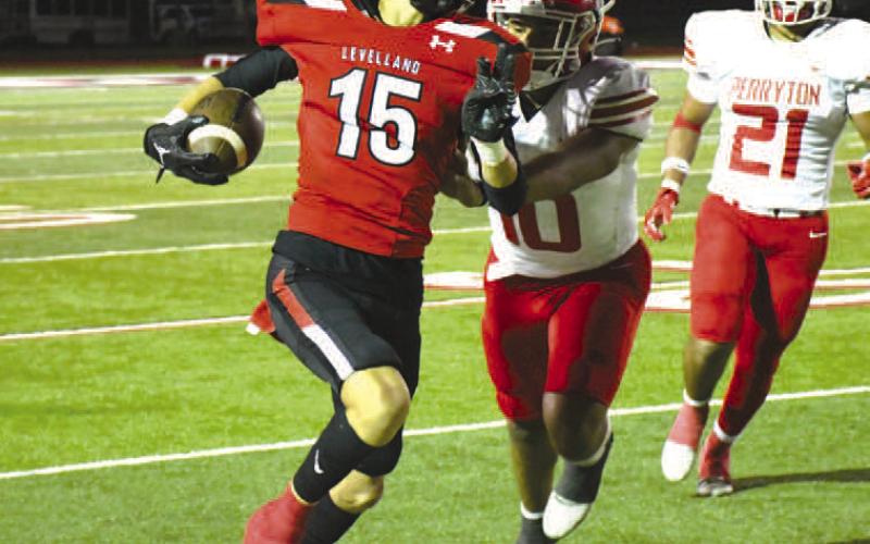 PUSHED OUT- Levelland Lobo Wyatt Baccus sprinted up the sideline before being pushed out of bounds by a Perryton defender. The Perryton Rangers handed the Lobos a 28-10 loss in their district opener at Lobo Stadium last Friday. (Staff Photo by Dom Puente)