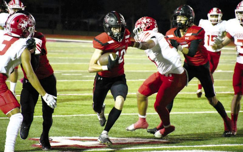 BREAKINGTACKLES- Mark Buxkemper is pictured breaking an arm to gain positive yards for the Lobos. The Lobos are now 1-6 overall and 0-1 in district play. Levelland will be on he road Friday in search of their first district win at West Plains. (Staff Photo by Dom Puente)
