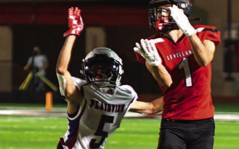 JUMP BALL - Pictured is Levelland Lobo receiver Ben Alvarado trying to high-point a pass thrown by quarterback Boston Winfield. (Staff Photo by Dom Puente)