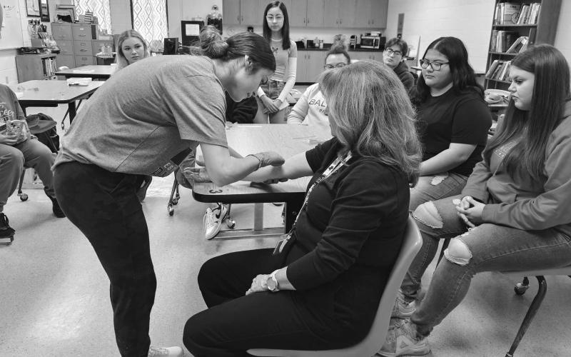 CTE CLASS- The LHS Patient Care Technician Course, taught by Mrs. Joan Sanders gives students an opportunity for a career after high school and is a great CTE class. Mrs. Sanders teaches Patient Care students what they need to become certified to become a Patient Care Technician. This month they are studying phlebotomy and are actually working on real people after much practice on dummies. (Photo from LISD)