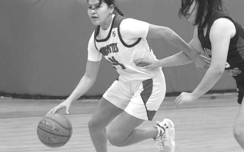DRIVING- Roughhette Natalie Urias drove to the basket against a Floydada defender. The Roughettes defeated Floydada, 49-36. Sundown will face Denver City on the road, Tuesday, November 15th. (Photo Courtesy of Chris Bratcher)