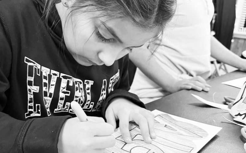 GRAFFITI ART-- Art teacher, Mrs. Mary Bara allowed third graders at South Elementary to trace their names using graffiti. The project introduced students to the origins of graffiti and helped students and teachers learn each other’s name for the upcoming year. Pictured is third grader Alexi Galindo. (Photo courtsey of Cristal Isaacks)