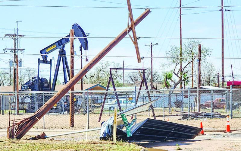 WIDESPREAD DESTRUCTION – Reported as intense straight-line winds, the Levelland community is continuing to clear out debris from various areas throughout the city. Electrical poles, street signs, and building materials were some of the various items scattered on roadways other properties after Wednesday mornings storm. Pictured is road debris on the corner of 2nd Street and Avenue C. (Staff photo by Dom Puente)