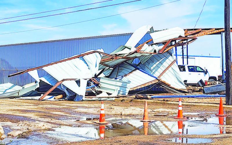 AFFECTED LIVELIEHOODS – Pictured is a collapsed parking structure belonging to Rose Equipment. Many businesses suffered severe damage from the Wednesday storm. Along with torn building materials were uprooted roofs, shattered windows and damaged product and collapsed buildings. (Staff photo by Dom Puente)