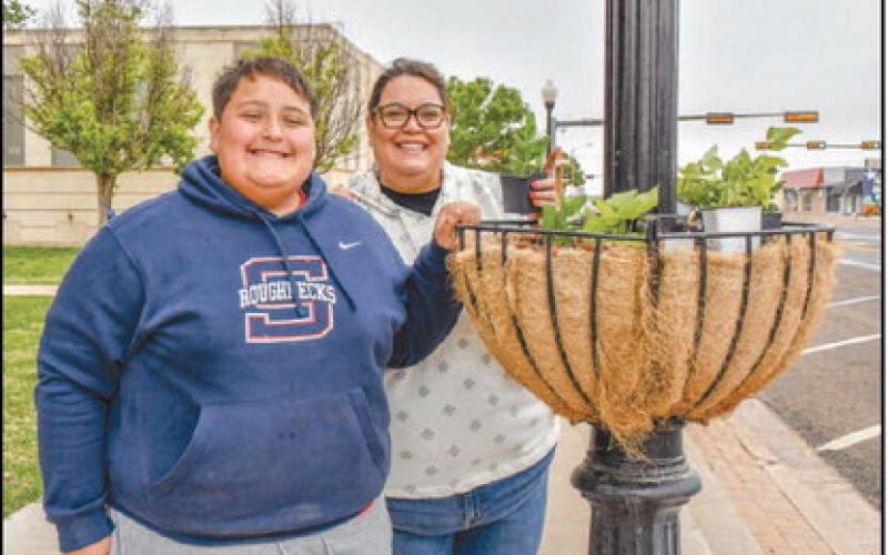 - Pictured is Luke and Esmeralda Rowand who spent their Saturday morning making downtown just a little greener for Community Planting Day. (Staff photo by: Hannah Woodrum)