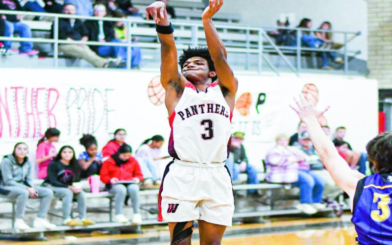 THREE-POINT THREAT - Whitharral Panther Brent Robinson shoots a three-pointer during their district game against Anton at Whitharral High School this past Thursday. Robinson would make three three’s in the win. (Staff photo by Jentezen Smith)