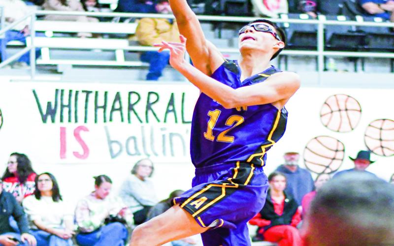 AVALOS BUCKET - Anton Bulldog Xavi Avalos goes up for a layup on a fast break during their district basketball game against Whitharral this past Thursday at Whitharral High School. Avalos would score six points in the loss. (Staff photo by Jentezen Smith)