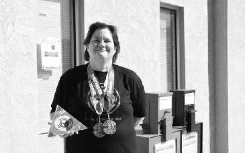 SPARTAN TRIFECTA - Katie Ervin earned her SPARTAN trifecta this past weekend. Here she is pictured with her medals and trifecta award. Earning the trifecta is a huge accomplishment and she is truly honored to have been able to earn it. (Staff photo by Hannah Woodrum)