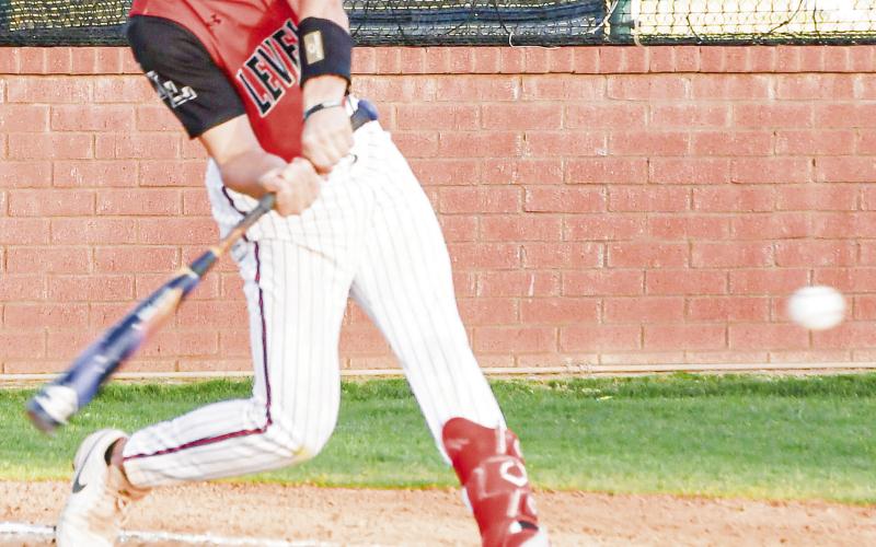POWER SWING - Levelland Lobo Jake Potter swings hard at a pitch during their district baseball game against Big Spring this past Tuesday night at the Lobo Diamond. (Staff photo by Jentezen Smith)