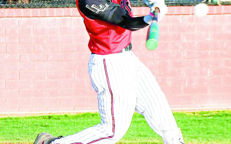 HIGH PITCH HITTER - Levelland Lobo Javier Ruiz swings at a pitch high up in the strike zone during their game against Big Spring this past Tuesday night at the Lobo Diamond. (Staff photo by Jentezen Smith)