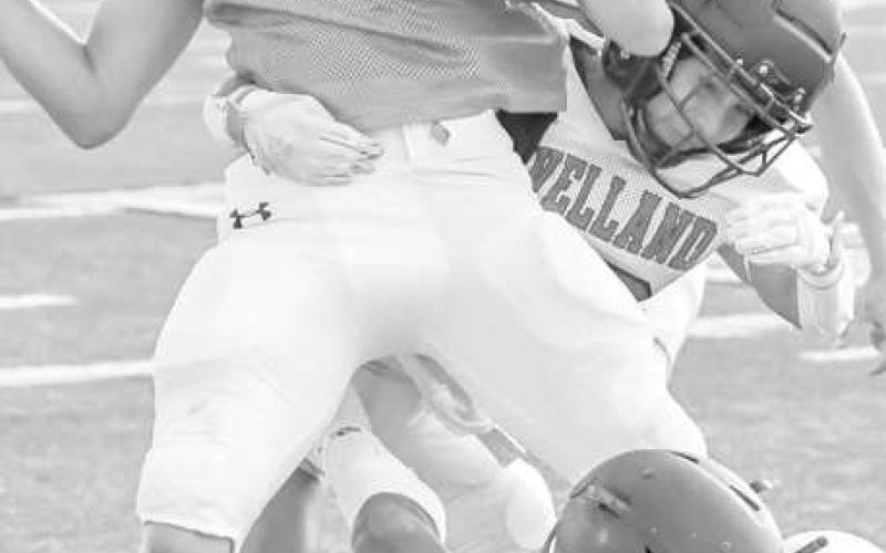 TEAMTACKLE - The Levelland Lobos had an away scrimmage against the Idalou Wildcats this past Friday. Pictured above are the Lobos defense bringing down a player. (Staff photo by Dom Puente)