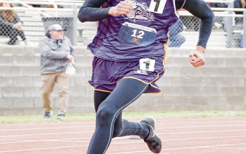 LEAN INTO THE CURVE - Anton Bulldog Xavi Avalos leans into the curve as he sprints during the 200-meter dash this past Friday at the Regional Championships at South Plains College. (Staff photo by Jentezen Smith)