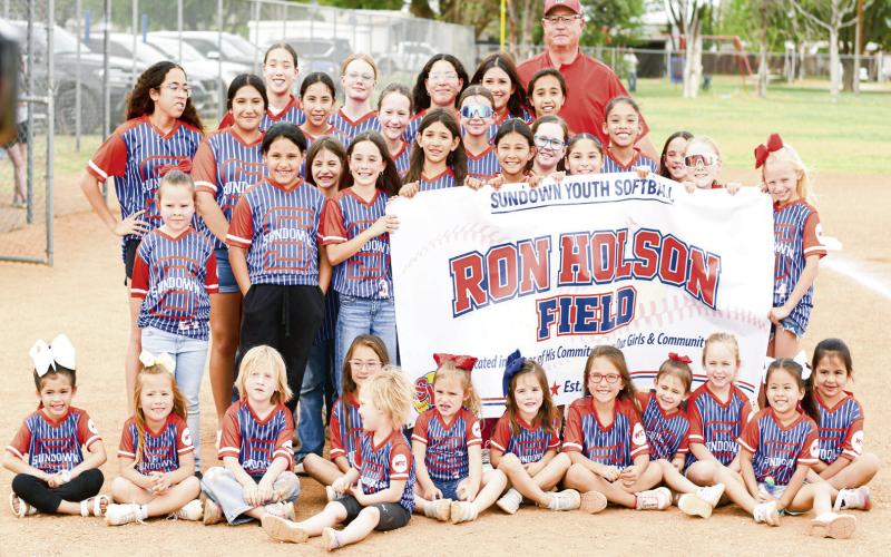 INVESTING IN THE NEXT GEN - Sundown’s Ron Holson poses for a group photo with the Sundown Youth Softball kids this past Thursday at Ron Holson Field in Sundown. Holson noted that his “why” in renovating the field was to invest in the next generation. (Staff photo by Jentezen Smith)