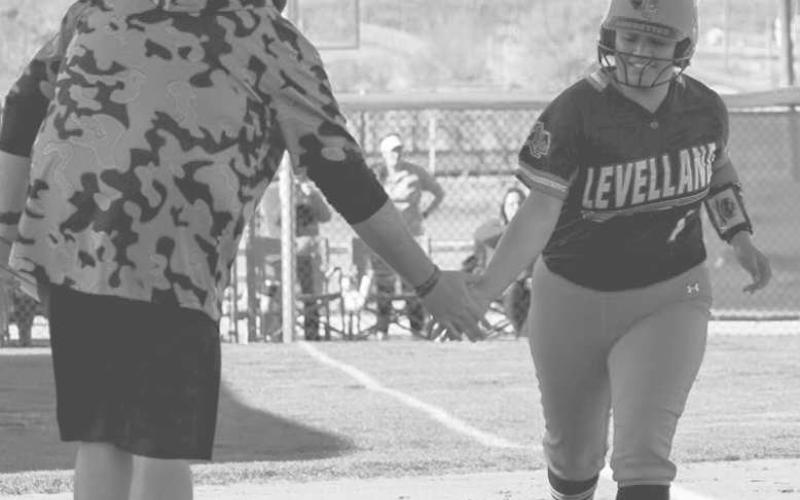POWER AT THE PLAYE - Levelland Loboette Angelica Gonzalez and Head Softball Coach Ryan Miller celebrated during her homerun trot as she came across third base to homeplate. Gonzalez wrapped up the game going 2-4 at the plate with two RBI’s. The Loboettes took the district road win against the Sweetwater Lady Mustangs, 6-1. (Staff photo by Aalijah Soliz)