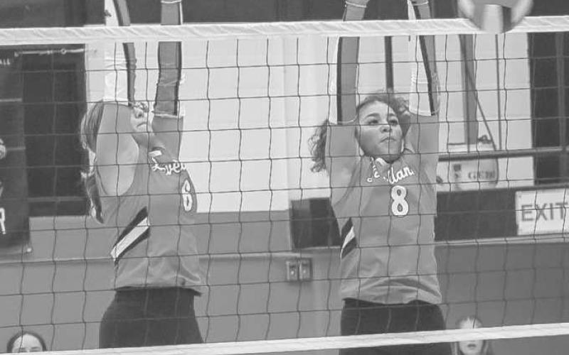 DEFENSE - Loboettes Hailiee Estrada and Mia Sepulbeda jumped up to block the spike from the Plains Cowgirls this past Tuesday at home for their regualr season game. (Staff photo by Aalijah Soliz)