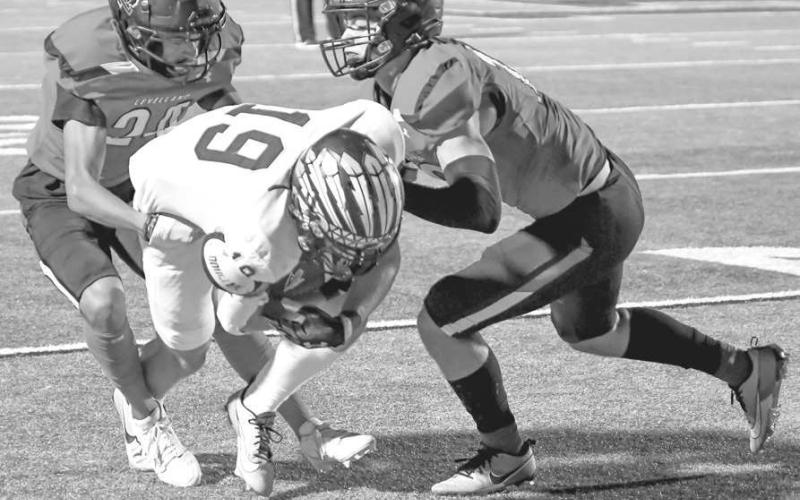 NOT OVER HERE - The Lobo defense played well as they wrapped up the offensive player for a short gain. (Staff photo by Dom Puente)