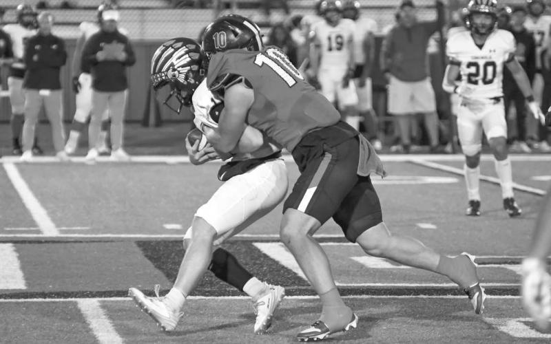STUFFED - Levelland senior athlete Rusty Johnson tackled the Seminole Indian ball carier behind the line of scrimmage in the teams last game of the season at home. Johnson was one of the few defensive leaders for the Lobos. (Staff photo by Dom Puente)