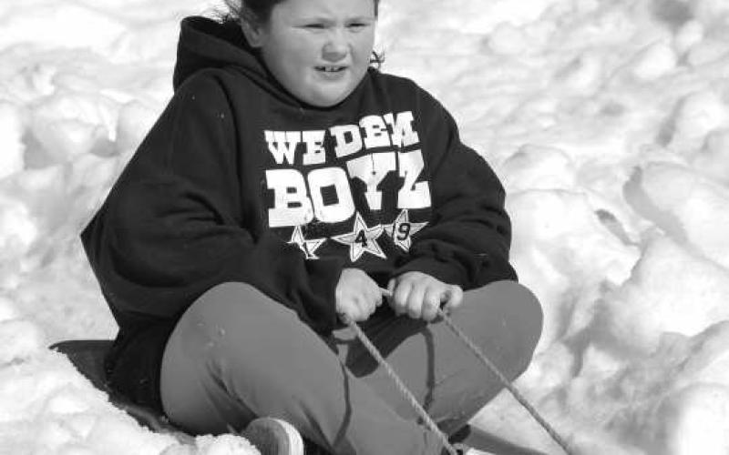 FROSTY CONDITIONS - Children were able to enjoy the Lobo Lake Sled Hill for a couple of days before the majority of the snow melted before the end of Thursday. Despite warmer temperatures throughout the week, dozens of children were able to make as many sled passes as they desired. (Staff Photo)