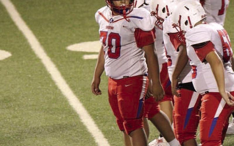 SUNDOWN O-LINE- Sundown eighth grader Tyson Reyes (70), communicates with his left guard to ensure they are on the same page as the Roughnecks were on the road again facing the Antelopes from Post to finish up the third game of district play. (Photo Courtesy of Sundown ISD)