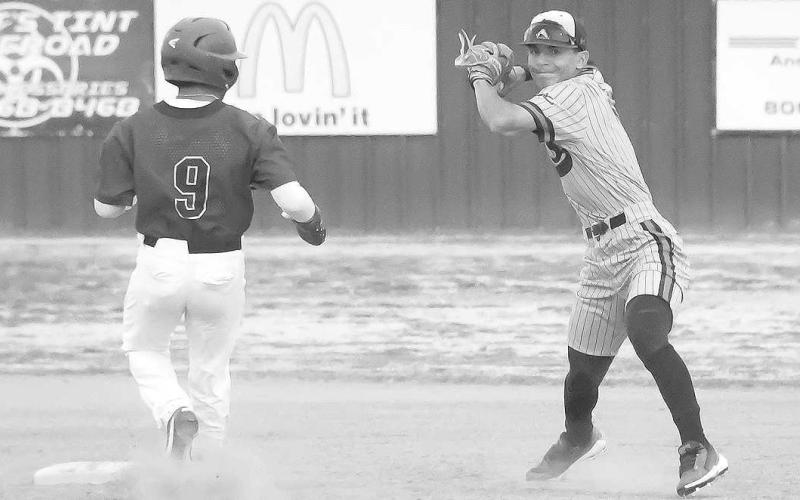DOUBLE PLAY- The Levelland Lobo varsity baseball team moved to 13-7 on the season with a 24-3 home win over the Tulia Hornets. Lobo second baseman Noah Tienda completed a double play with a throw to first. (Staff Photo by Dom Puente)