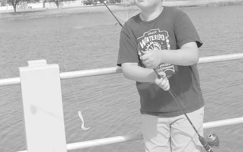 SUMMER FISHING- Aulidas Burton was out fishing at the Levelland Fishing Camp at Lobo Lake to have fun with parents and other kids with the same hobby on July 6, 2023. (Staff Photo by Aalijah Soliz)