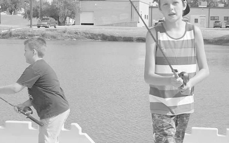 DETERMINED- Tristan Neal was out at the Levelland Fishing Camp. Neal was getting set up for a cast that he was about to throw out at Lobo Lake July 6, 2023. (Staff Photo by Aalijah Soliz)