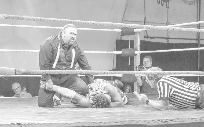 SUBMISSION HOLD- Wrestler Skar holds down Mack the Franchise by his injured arm during the match July 1 at 7pm. (Staff Photo by Aalijah Soliz)