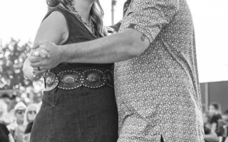 DANCING IN THE MOONLIGHT - Cotton and Crude had the biggest turnout on Saturday night at the Oxy Sport Complex. Couples and friends were dancing and laughing with the performers as they waited for the main event, Randall King. (Staff photo Hannah Woodrum)