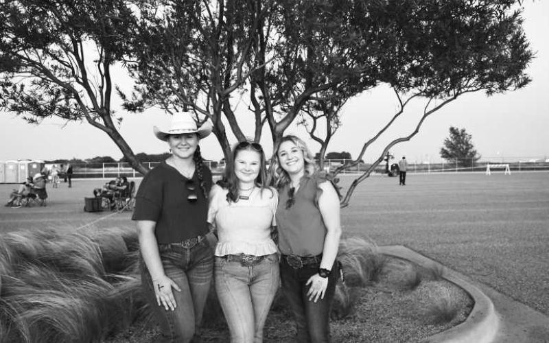 CONCERT NIGHT - These group of friends were rallying it up at the Cotton and Crude festival on Saturday night at the Oxy Sports Complex. (Staff photo by Hannah Woodrum)