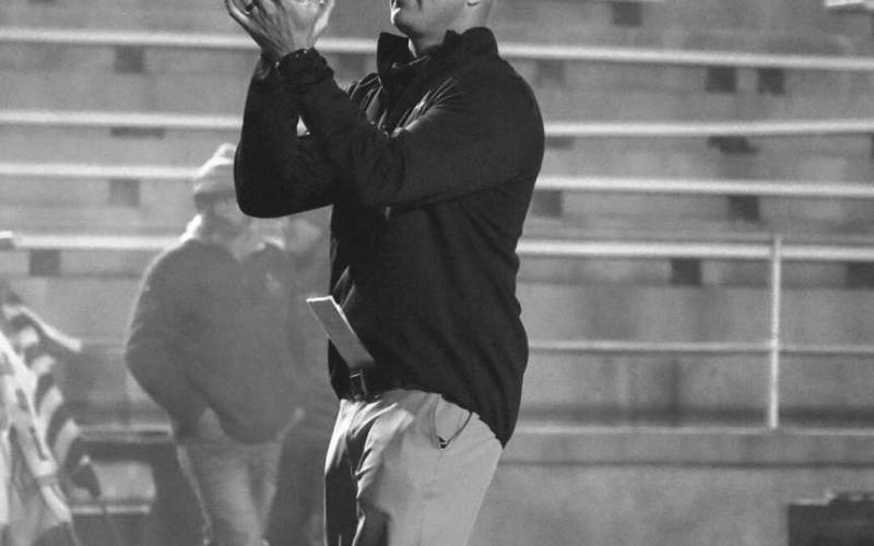 CLAP IT UP - Ropes Head Football Coach Beau Riker warmed up his team during their last game against Gruver in Canyon. (Staff photo by Aalijah Soliz)