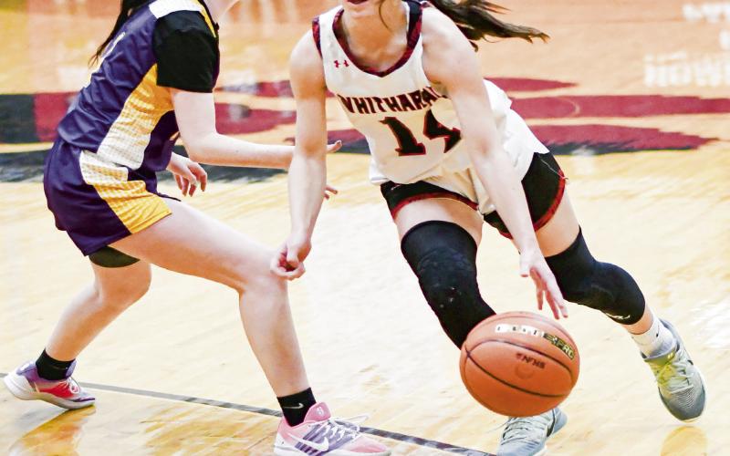 CERTIFIED BUCKET - Whitharral Lady Panther Paige Smith dribbles past an Anton defender during their district game at Whitharral High School this past Thursday. Smith would score 24 points in the win and be honored in the postgame for surpassing 2,000 career points. (Staff photo by Jentezen Smith)